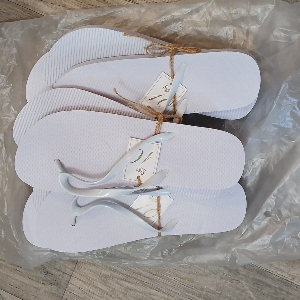Bag of white new flip flops